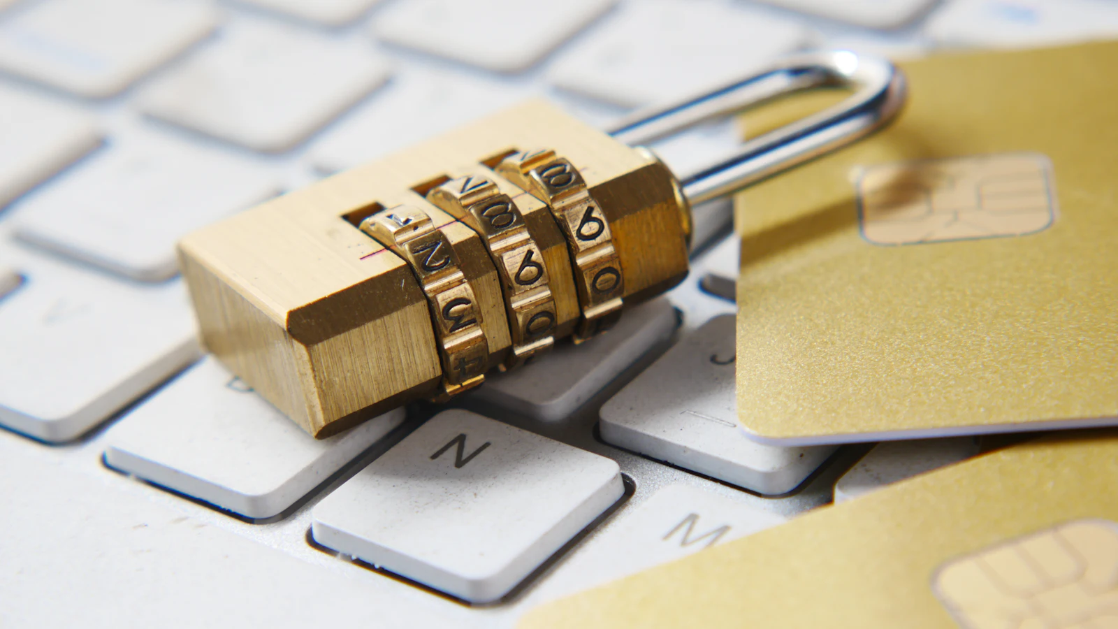 A combination padlock resting on a computer keyboard
